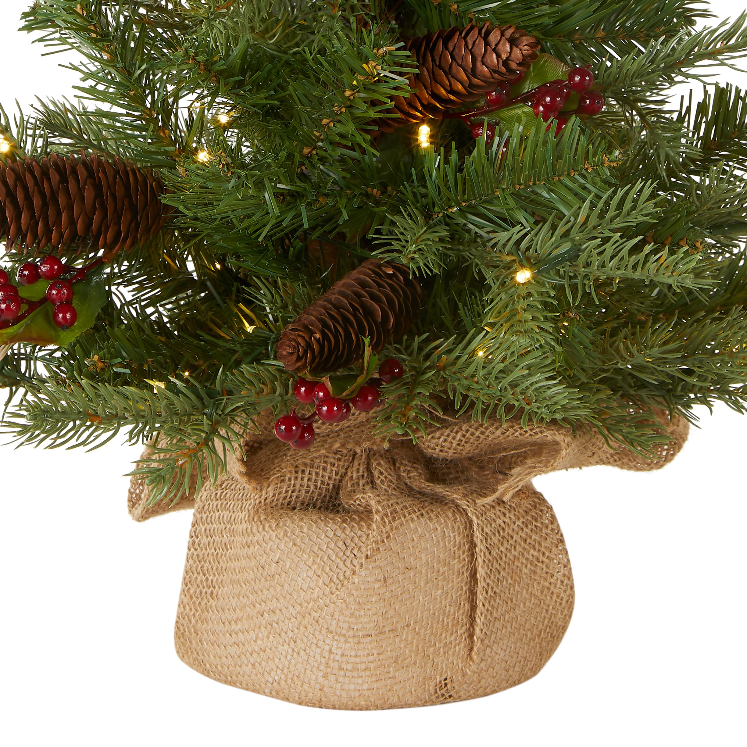 National Tree Company tree on a table lit with battery lights demonstrating compact placement