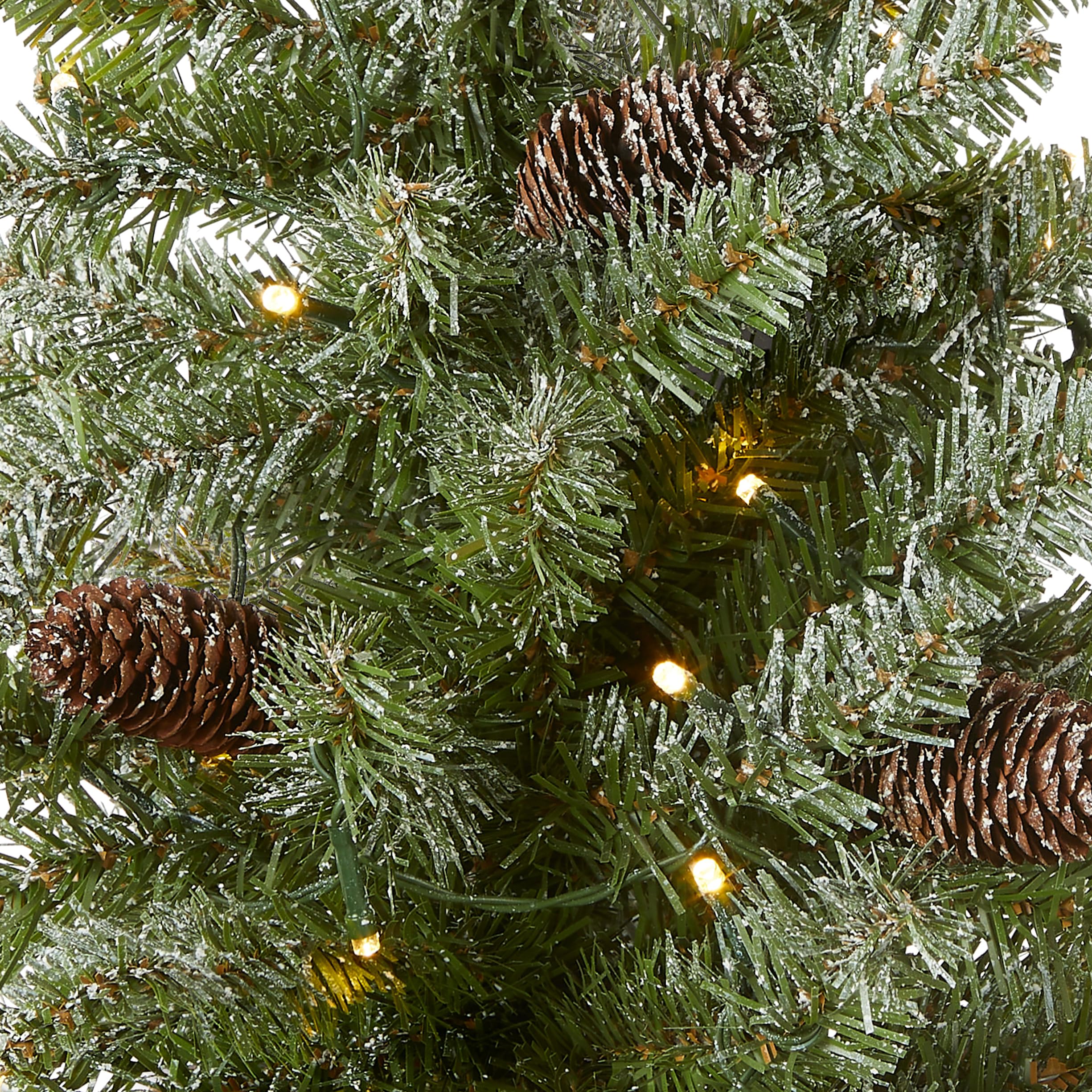 National Tree Company close-up of flocking and pine cone detail, realistic texture benefit