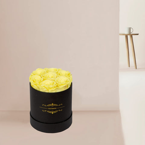 NATROSES hand holding a rosebud to show scale and indicate compact decorative size