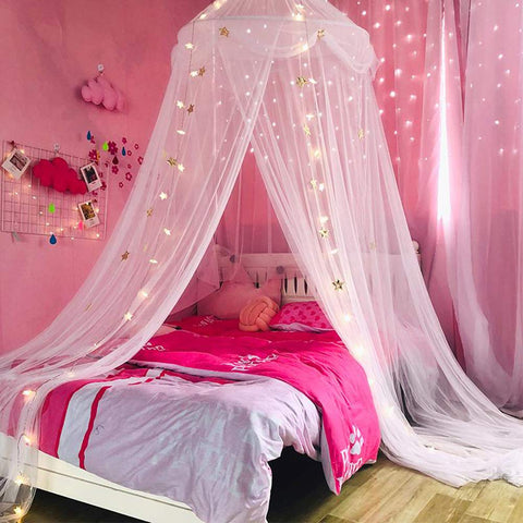 Nattey canopy lit with string lights at night, creates warm reading-nook ambiance