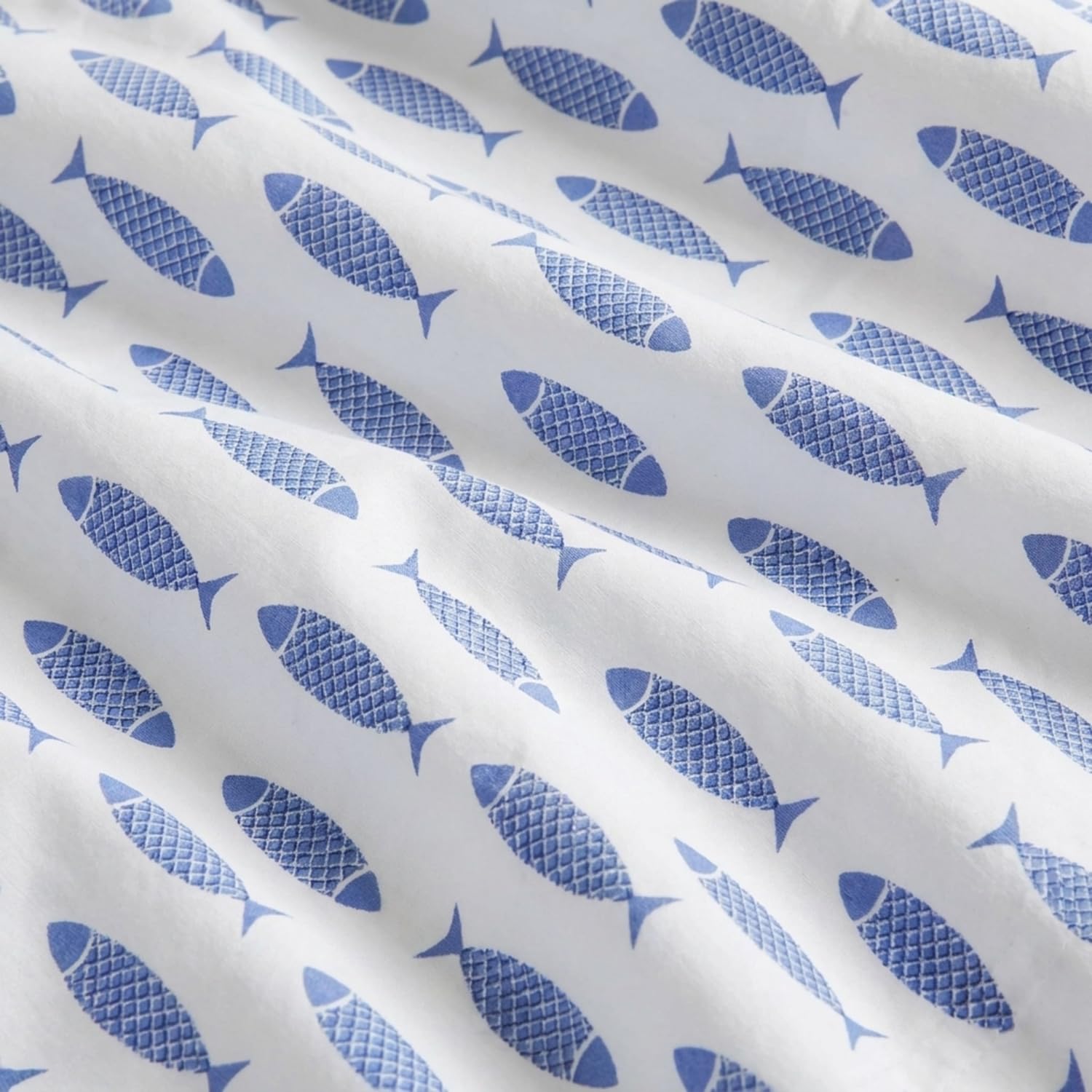 Nautica flat sheet draped on bed illustrating generous tuck-in length