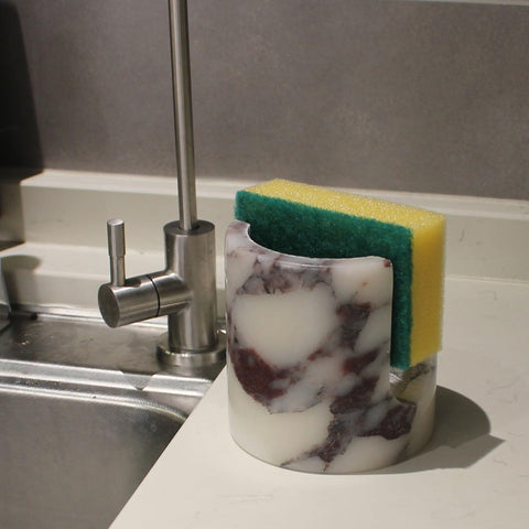 Nawgnail sponge in holder on sink demonstrates fast runoff and tidiness benefit