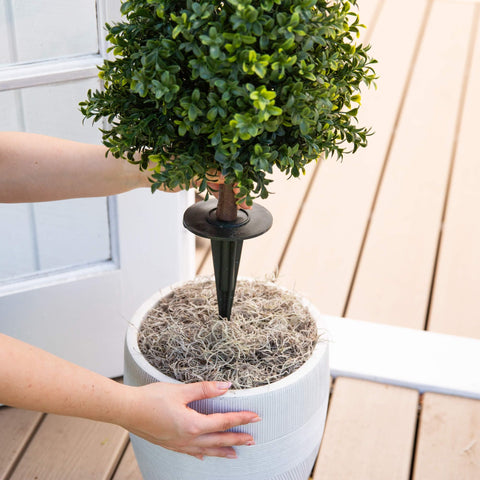 Nearly Natural boxwood in urn on porch creating symmetrical doorstep accent