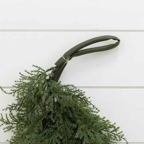 Nearly Natural garland framing a covered porch entry showing sheltered outdoor use benefit