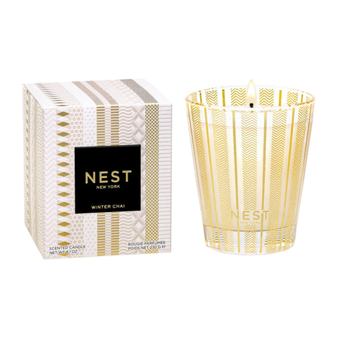 NEST New York candle front view showing festive glass and warm glow benefit
