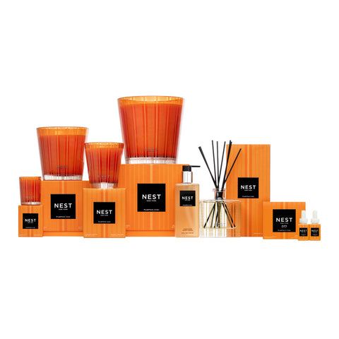 NEST New York candle in cozy living room setting, creates seasonal warm inviting atmosphere