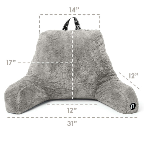 Nestl pillow styled on bed with person reading showing improved upright comfort