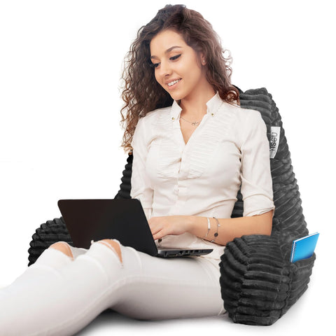 Nestl next to a book showing scale and clear hand support for comfortable lounging