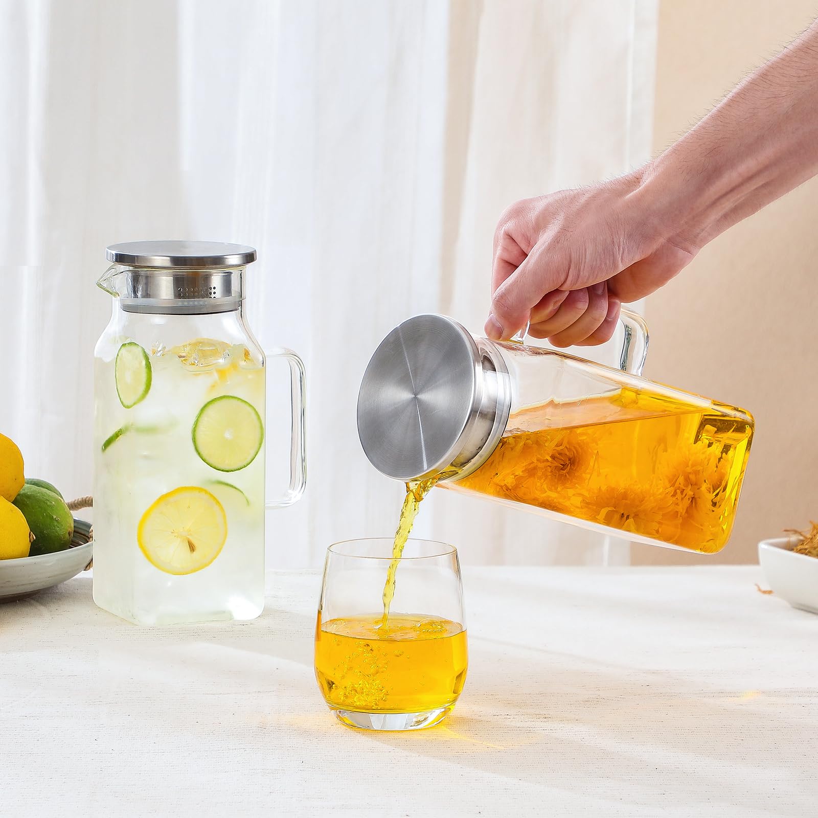 NETANY pitcher next to a drinking glass illustrating true 40 oz capacity