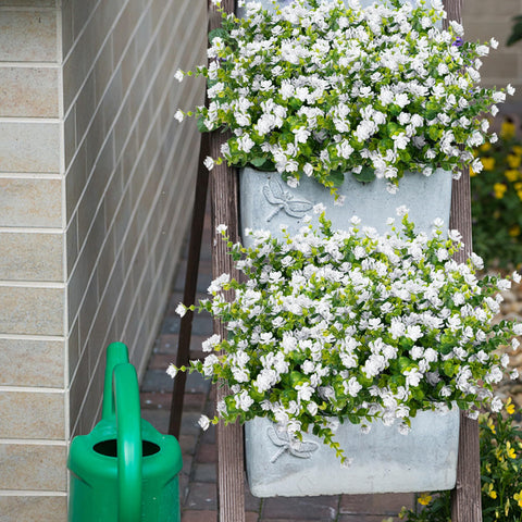 NETAP white artificial flowers arranged in a patio planter adding year-round color