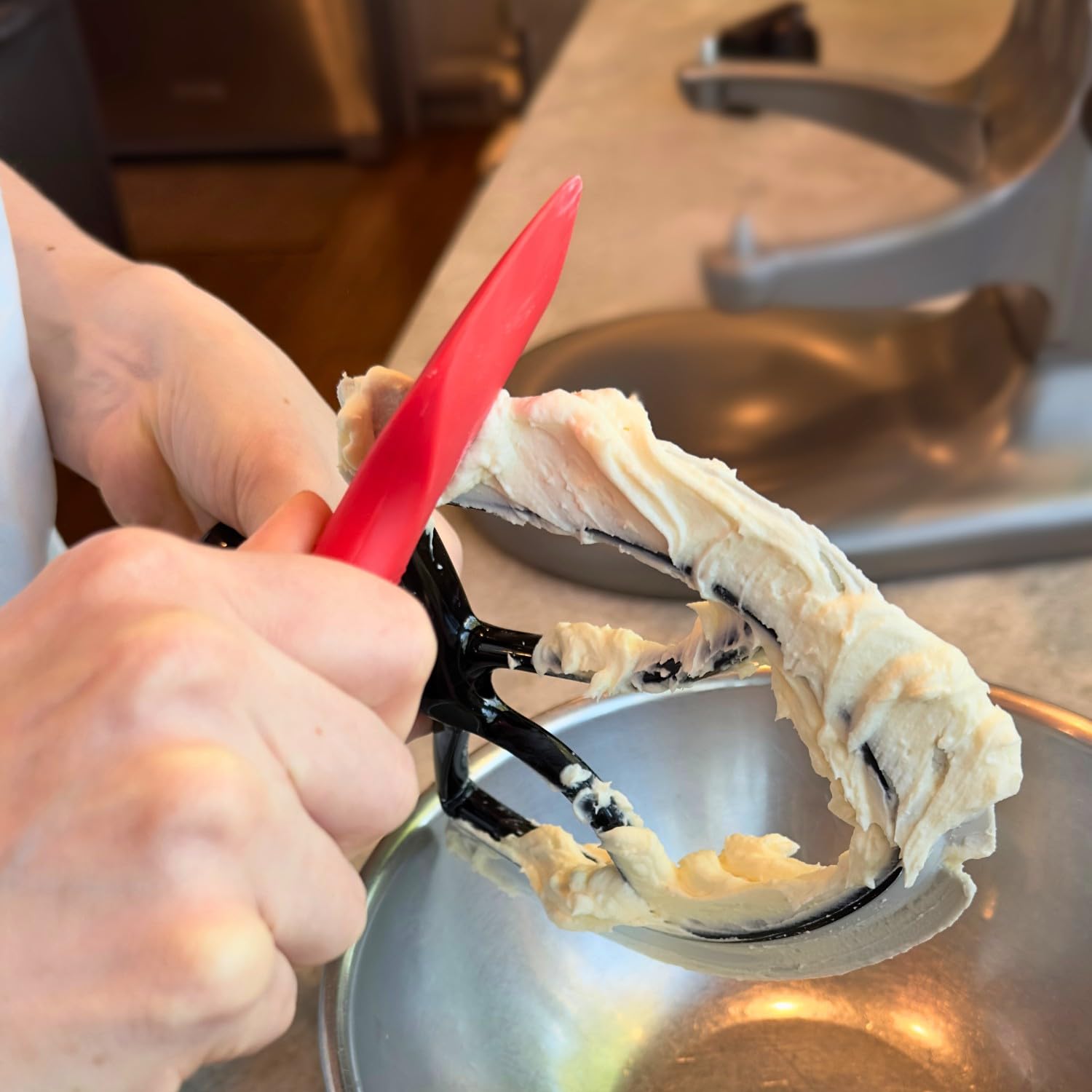 New Metro Design spatula cleaning mixer beaters to reduce batter waste
