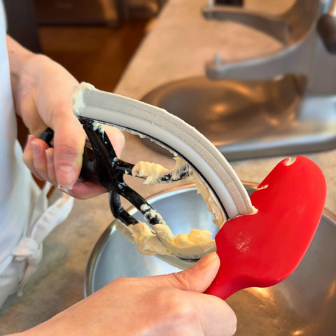 New Metro Design spatula resting on skillet edge for hands-free convenience