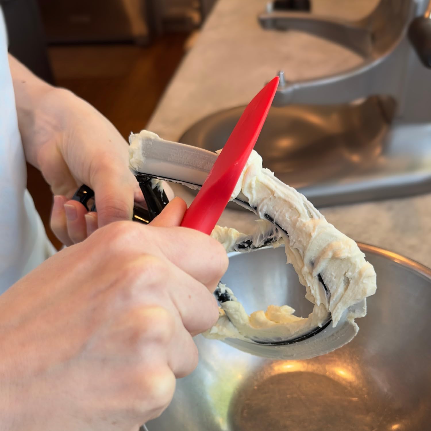 New Metro Design spatula scooping batter into pan for precise transfer