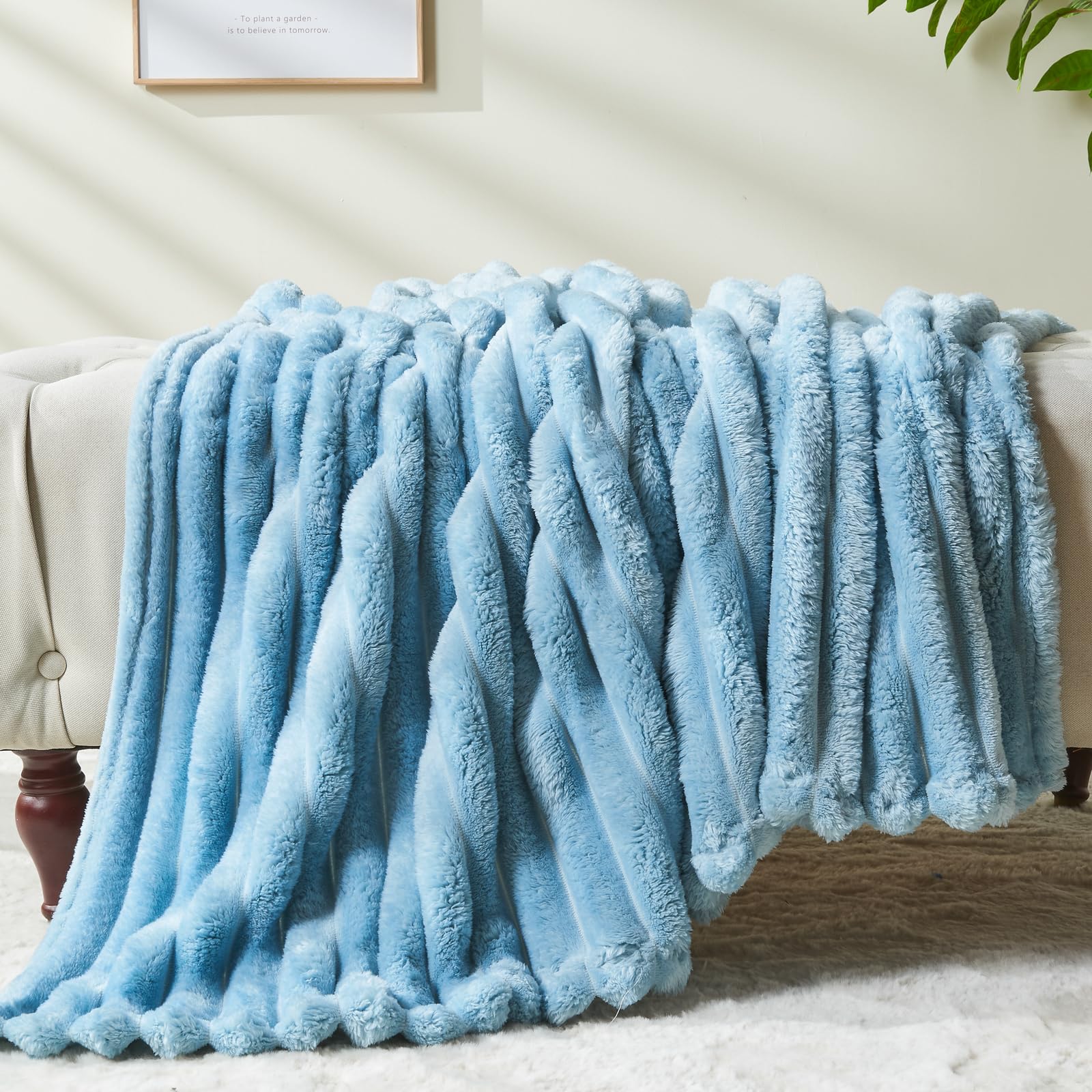 NEWCOSPLAY folded blanket beside pillow showing compact storage and scale