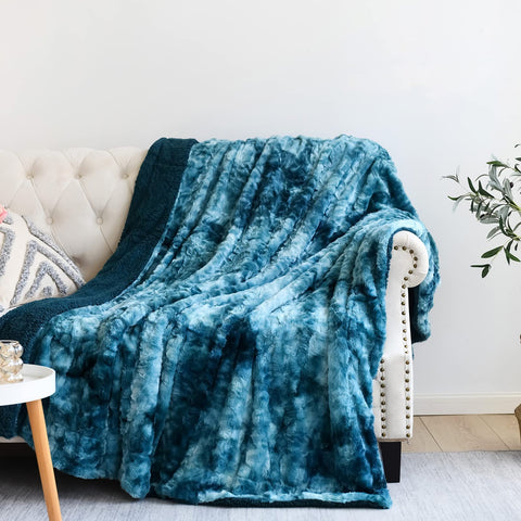NEWCOSPLAY dark blue throw folded on surface shows plush faux fur and cozy look