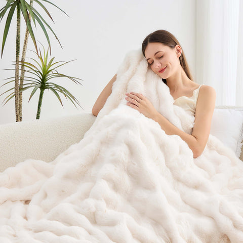 Nobleer throw spread on bed adding plush décor and lightweight warmth