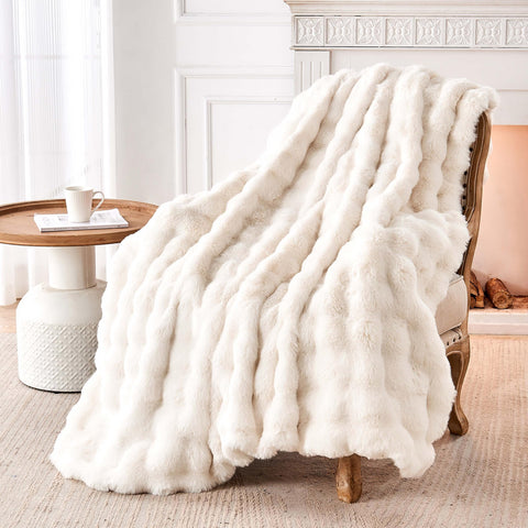 Nobleer throw draped on sofa creating a warm, elegant living room accent