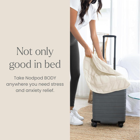 nodpod size next to hand displaying compact scale for easy travel