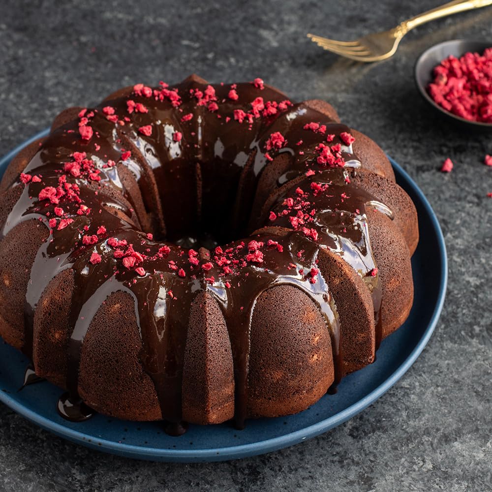 Nordic Ware Bundt pan on table with cake and serving pieces showing celebration-ready presentation benefit