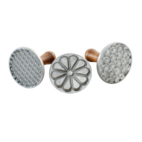 Nordic Ware front view of three cast-aluminum cookie stamps showing designs and handles, durable results