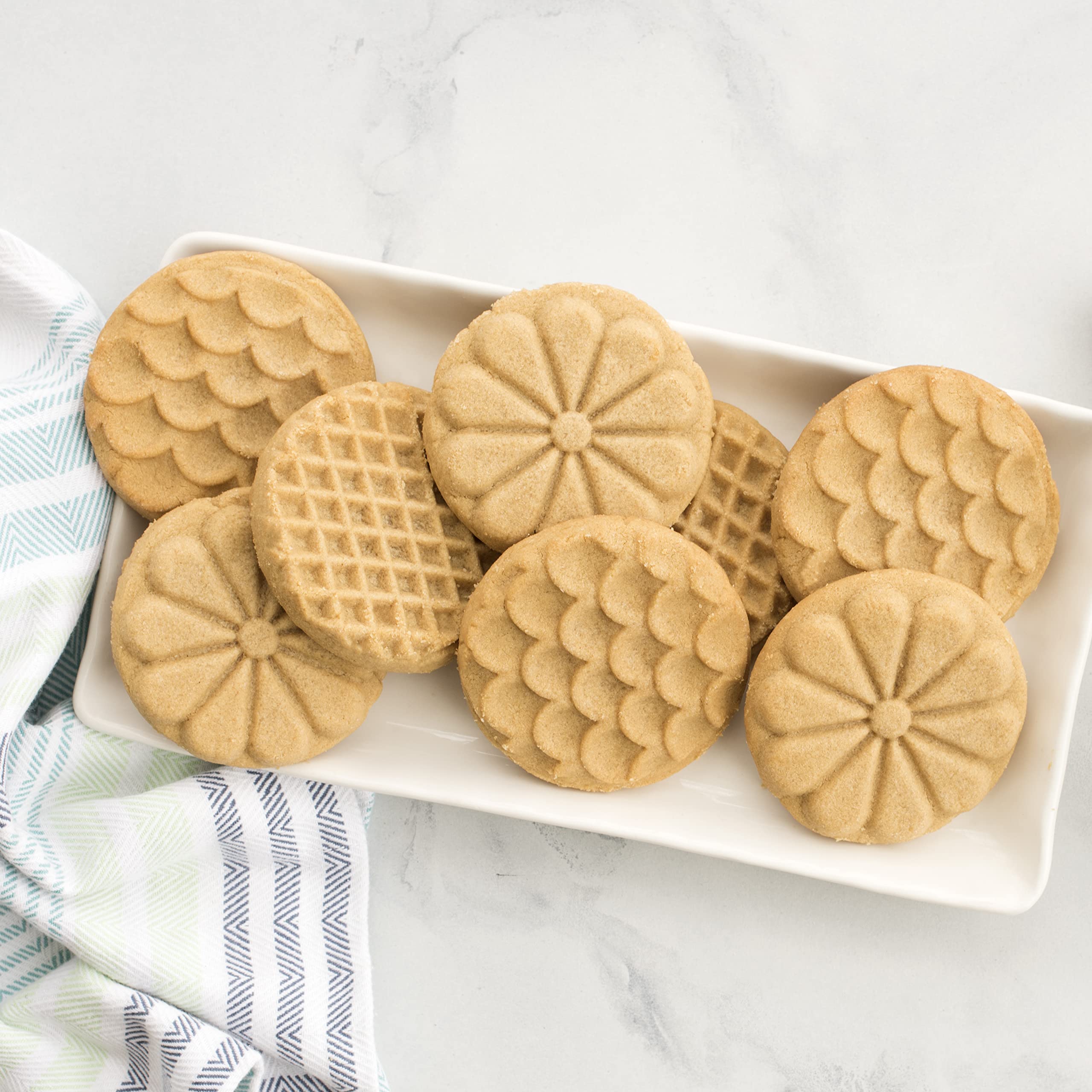 Nordic Ware wooden handle close-up showing ergonomic grip for controlled cookie pressing