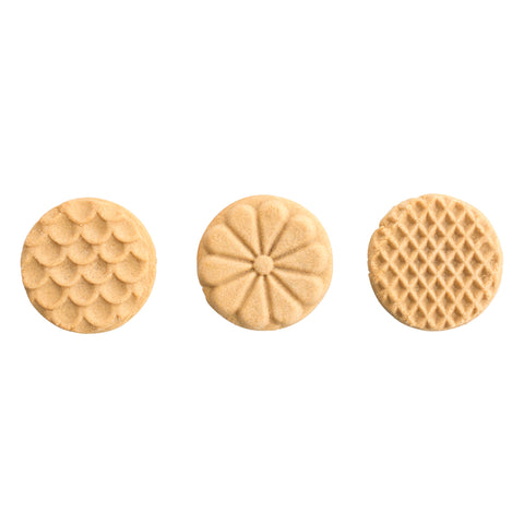 Nordic Ware cookie stamp in use pressing into dough for fast consistent decorative cookies