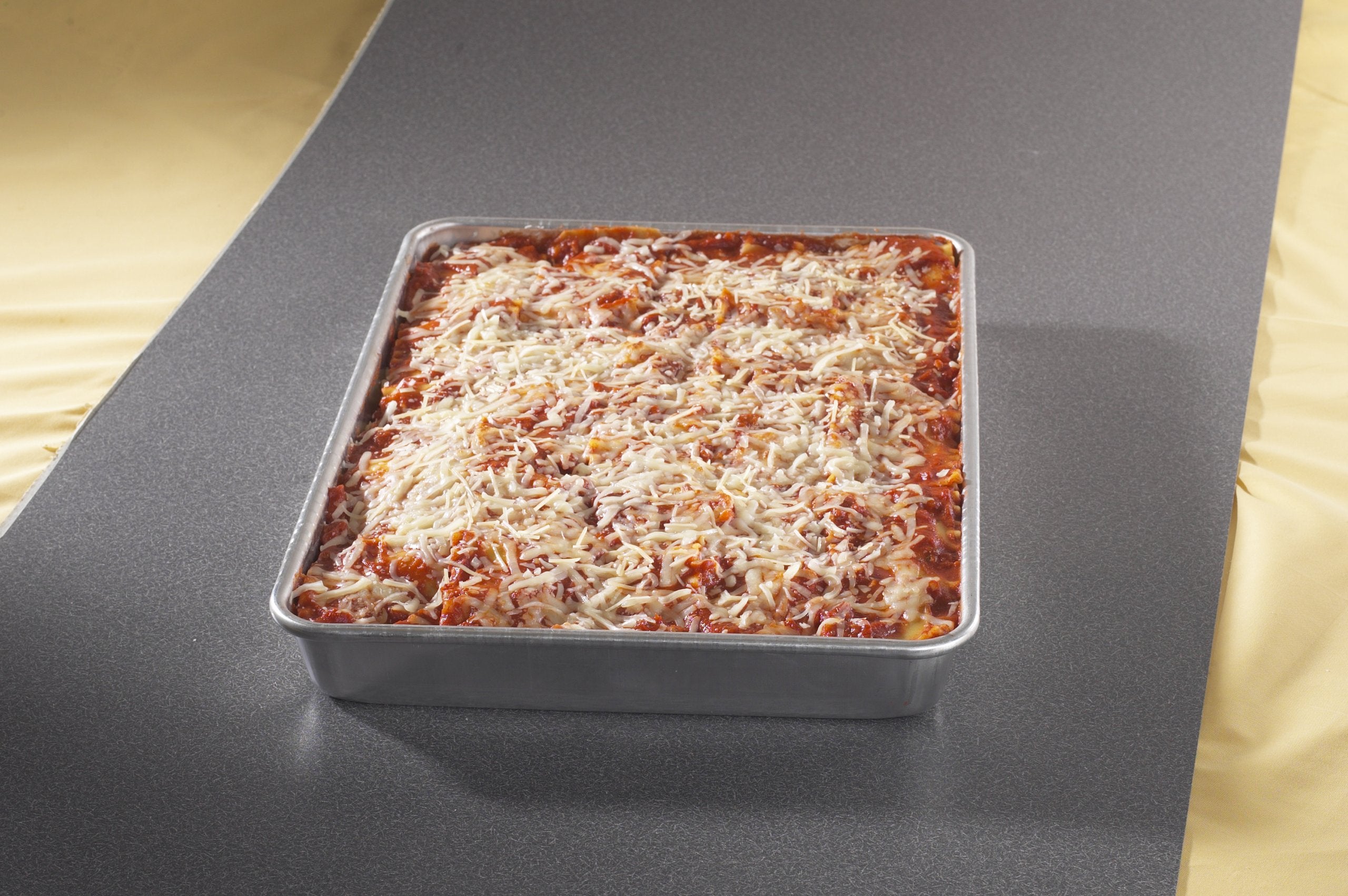 Nordic Ware pan in oven with a baked cake demonstrating even browning and capacity