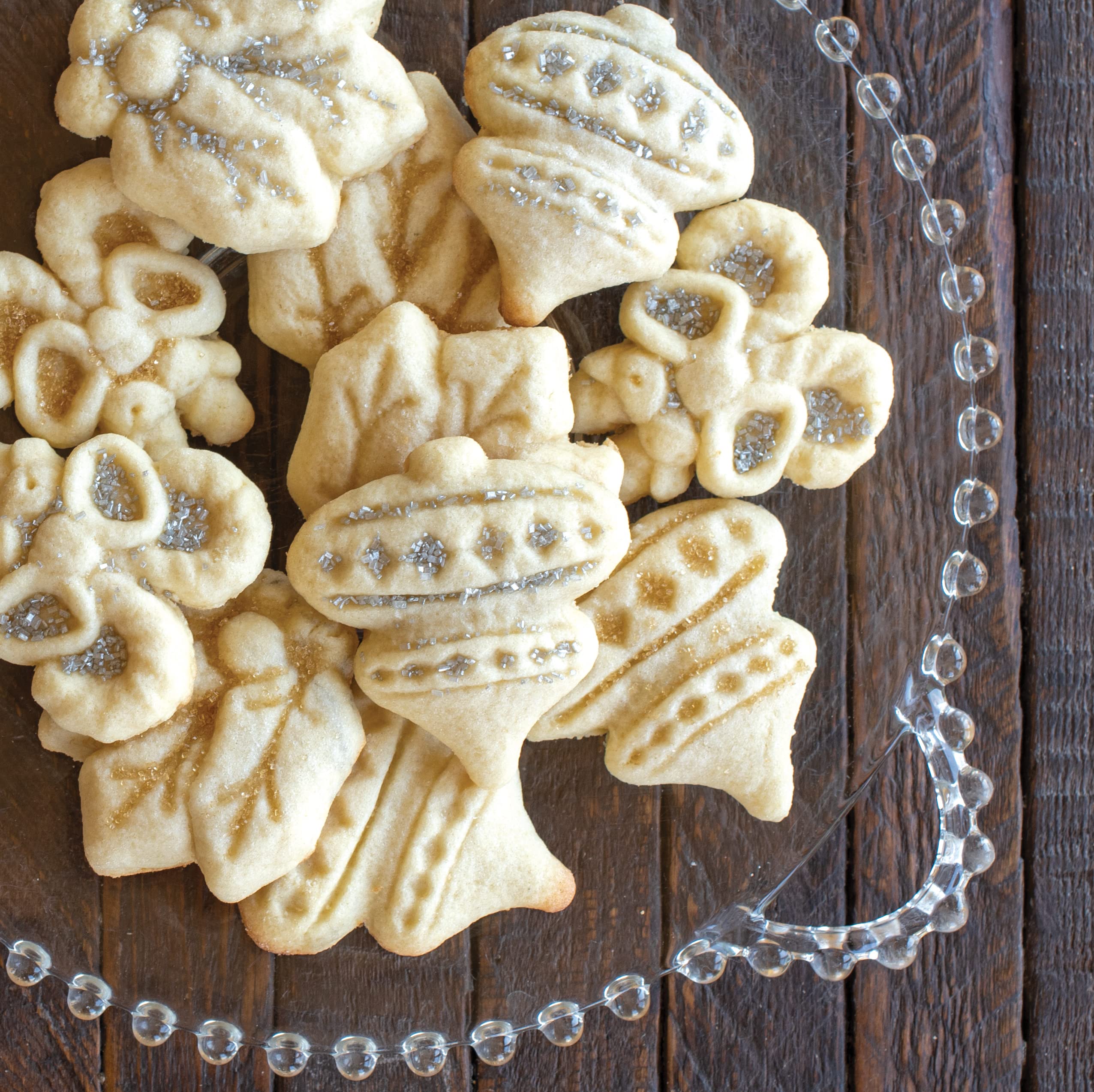 Nordic Ware stamping a cookie ball onto a baking sheet demonstrating easy press use