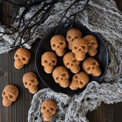 Nordic Ware baked skull cakelets cooling in pan showing easy release and uniform browning
