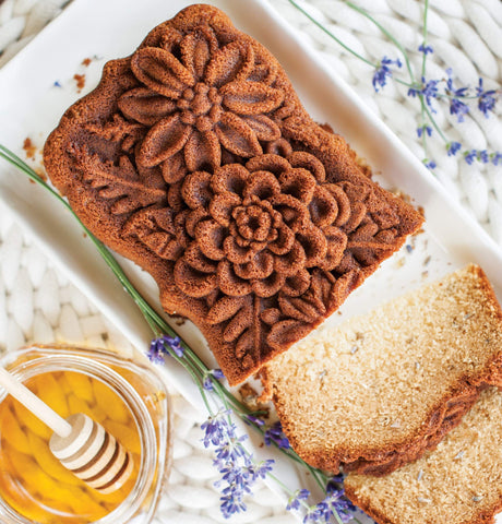 Nordic Ware pan holding baked loaf with floral top demonstrating clean release and attractive crust