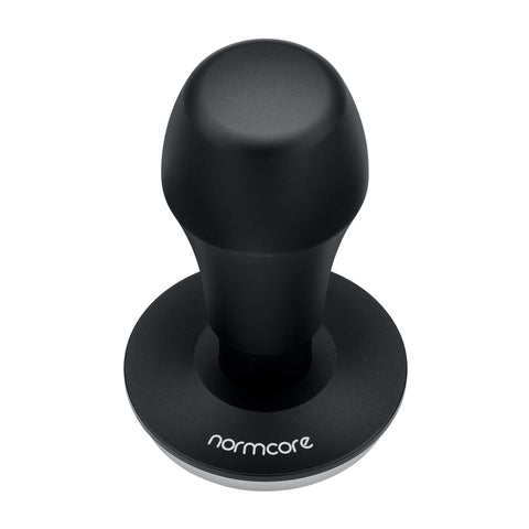 Normcore tamper being used to tamp espresso puck demonstrating self-leveling action and consistent pressure
