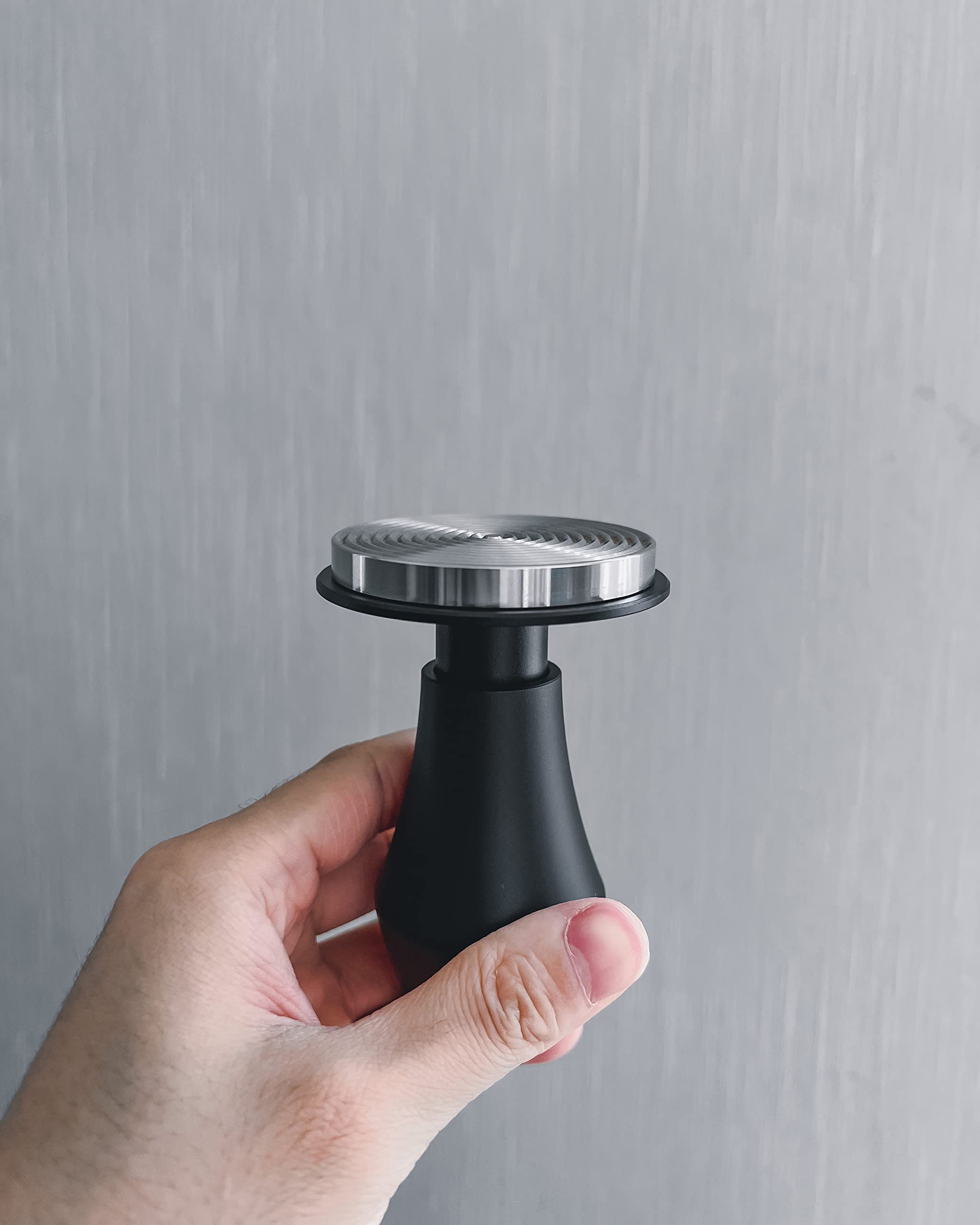 Normcore tamper beside ruler showing 53.3mm fit accuracy benefit