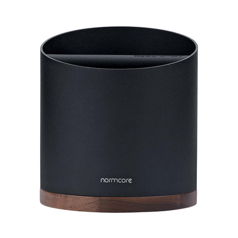 Normcore close-up of walnut base with rubber pads providing stability and counter protection