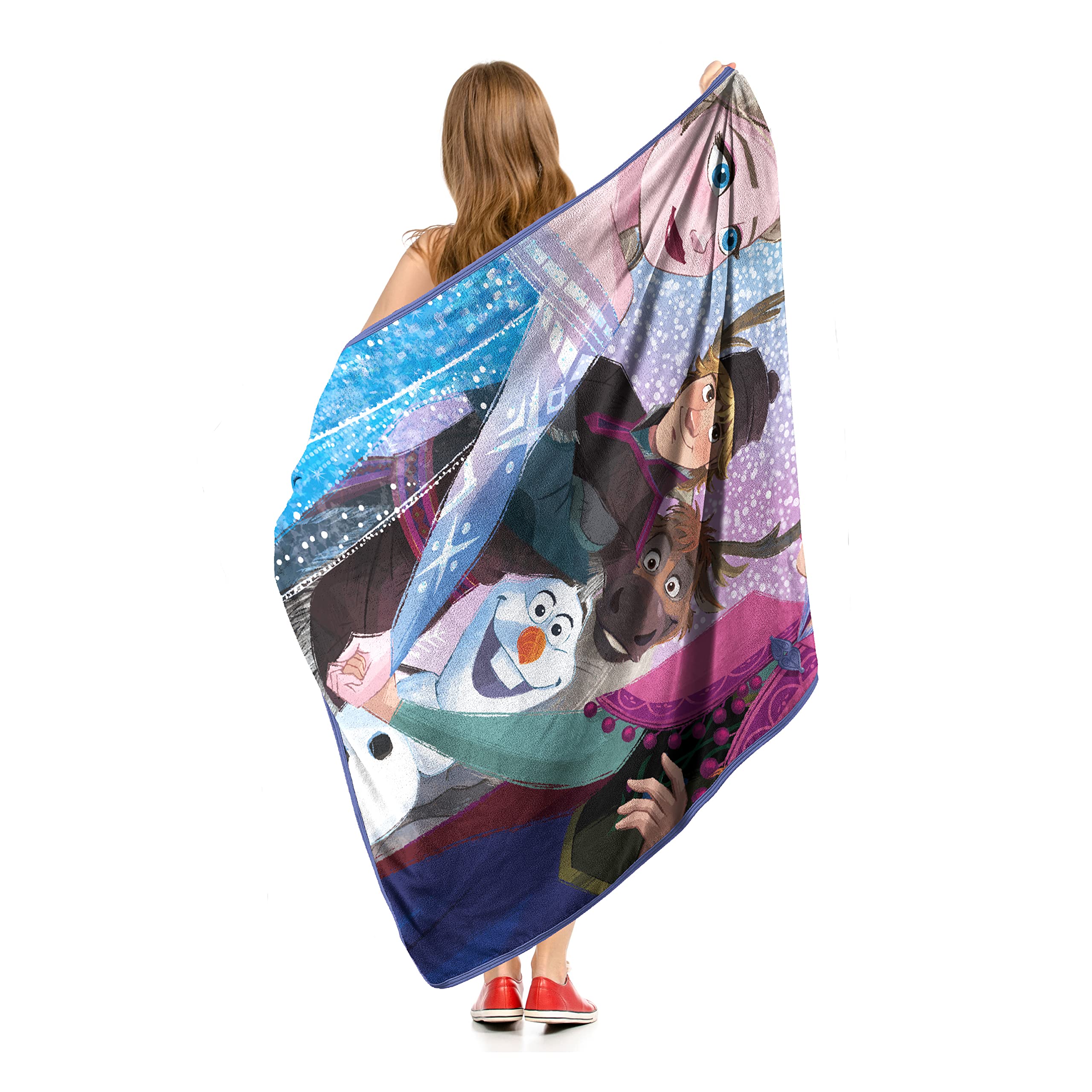 Northwest throw beside a person for size comparison showing 46x60 usefulness