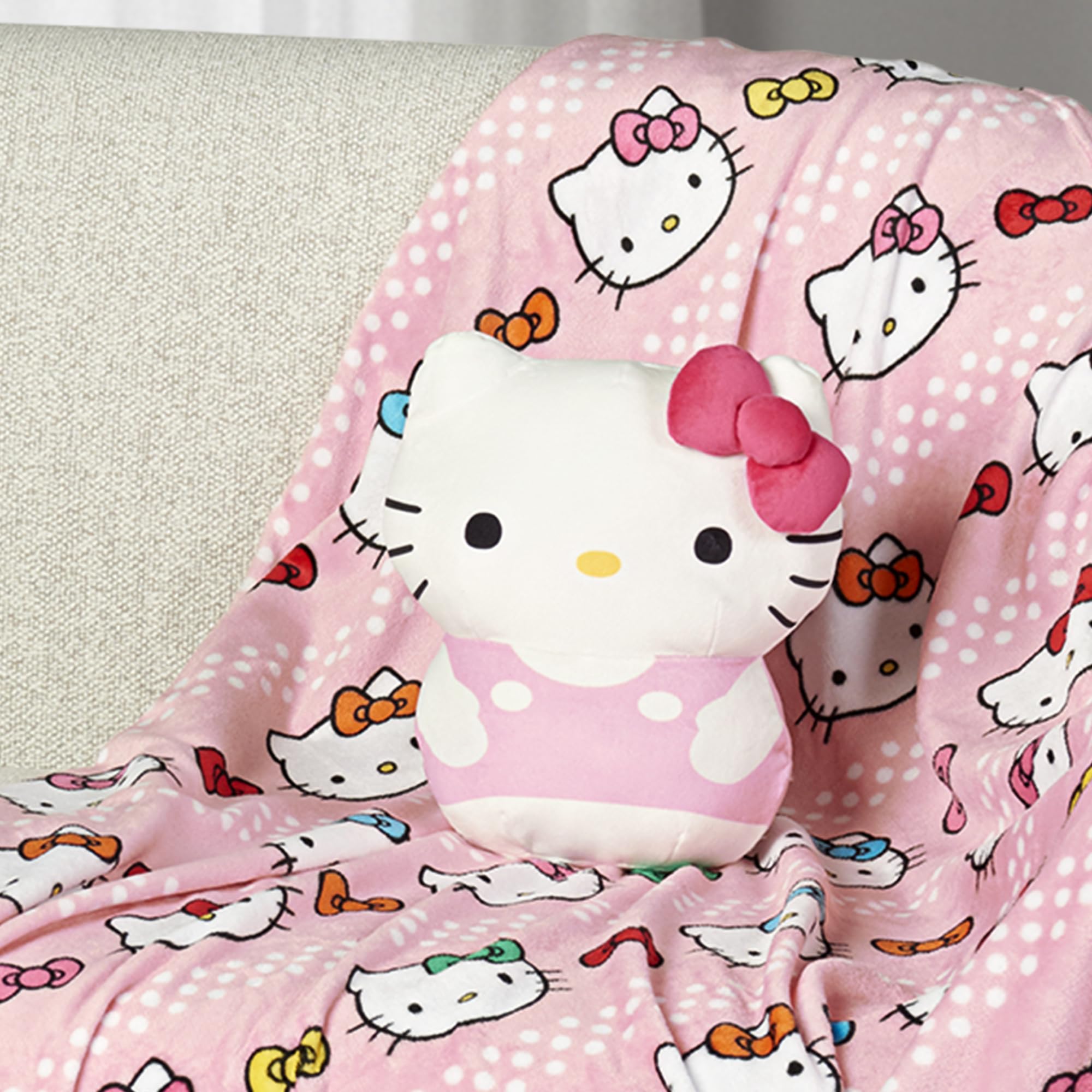 Northwest Hello Kitty blanket pattern close-up showing silky texture and colorful bows