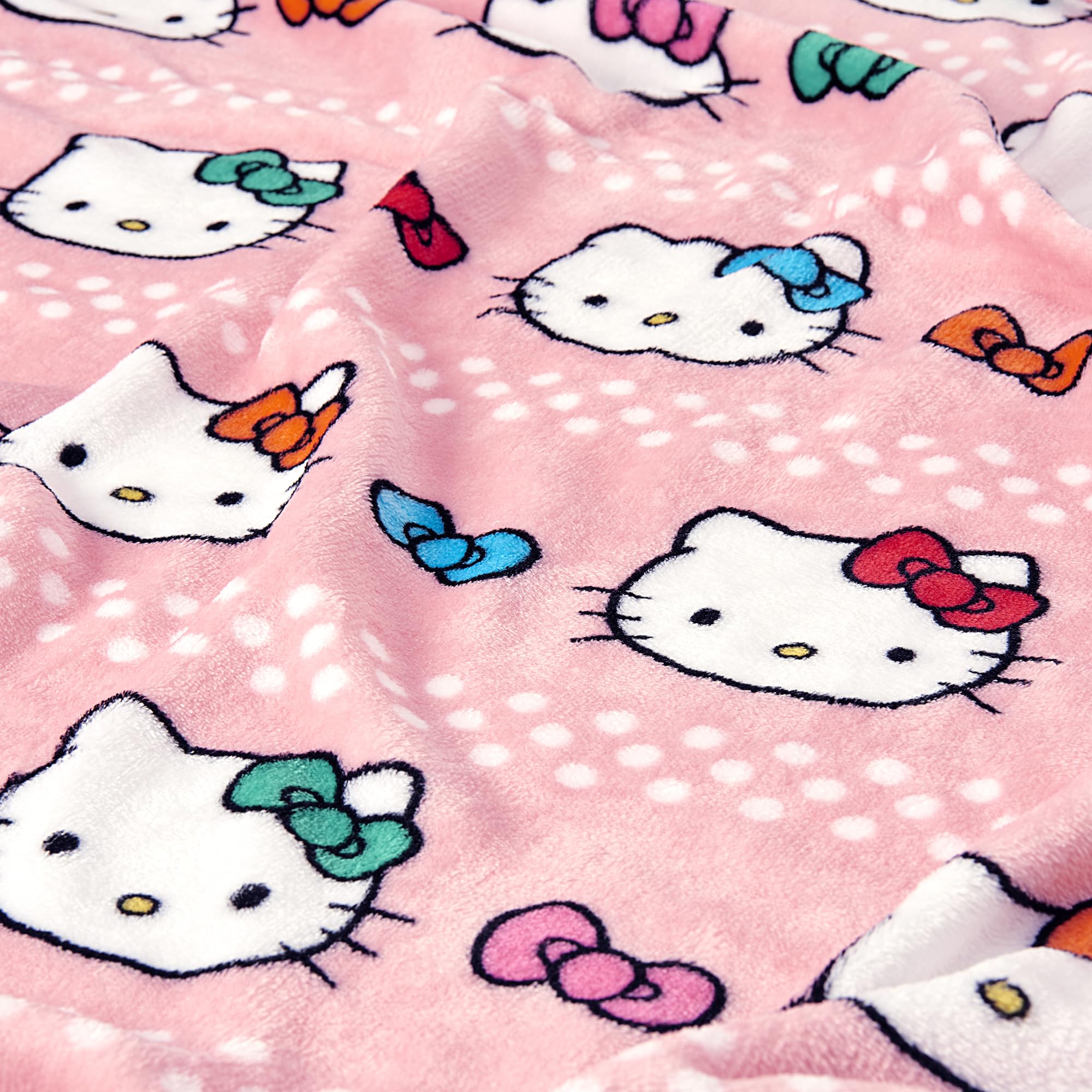 Northwest Hello Kitty hugger next to ruler showing 11-inch size and travel portability
