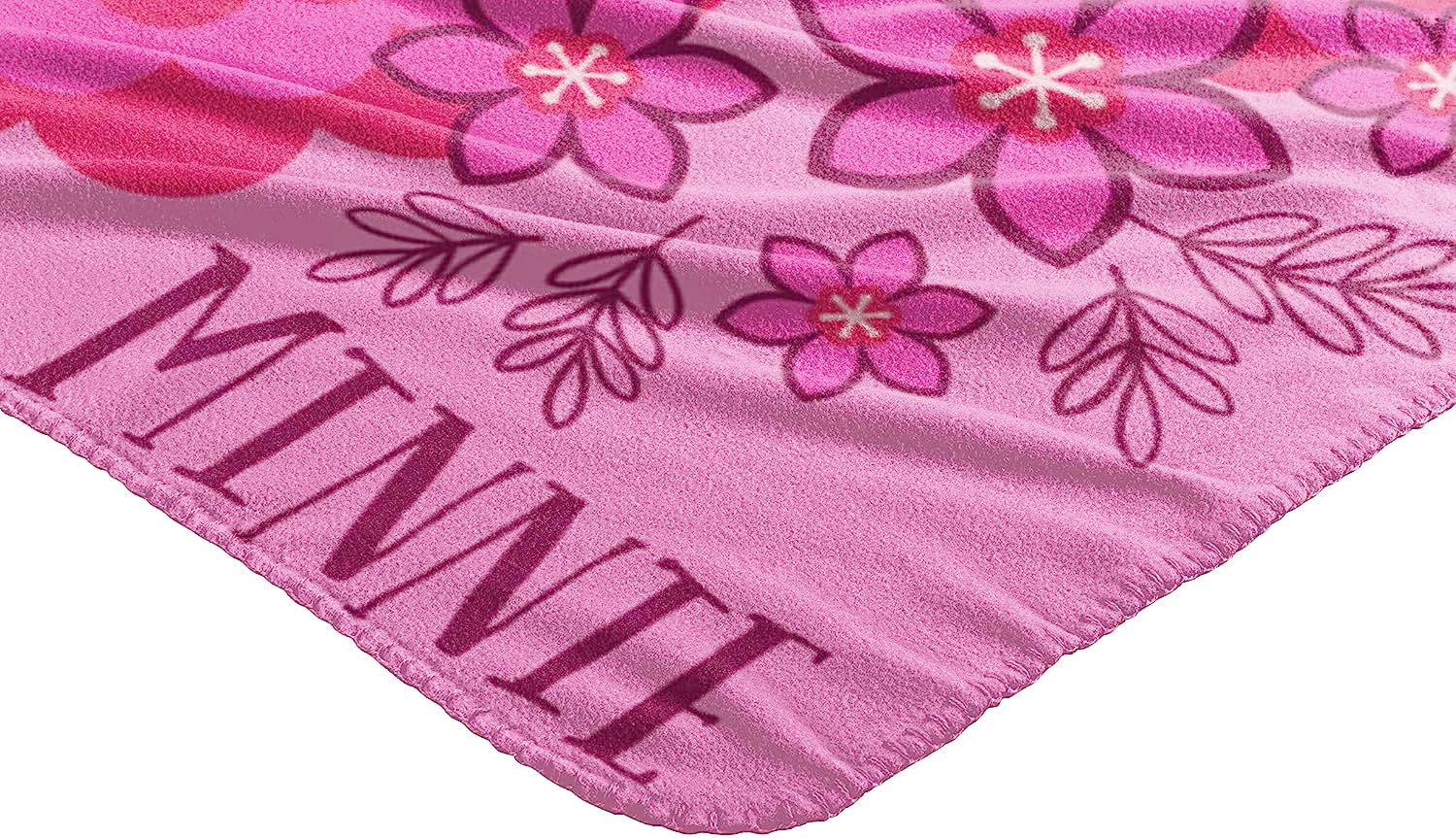 Northwest Minnie Mouse throw draped on sofa adding playful Disney decor