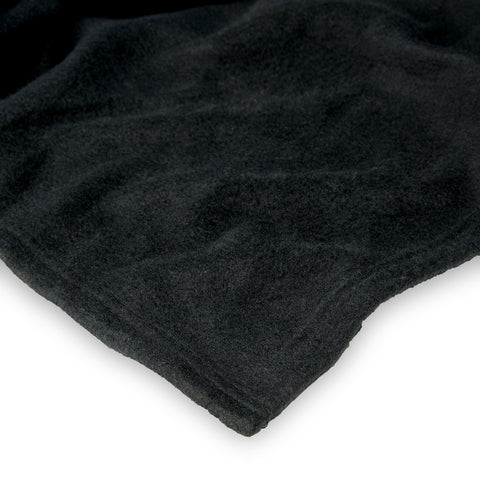 Northwest size comparison on chair showing generous 48x71 inch coverage