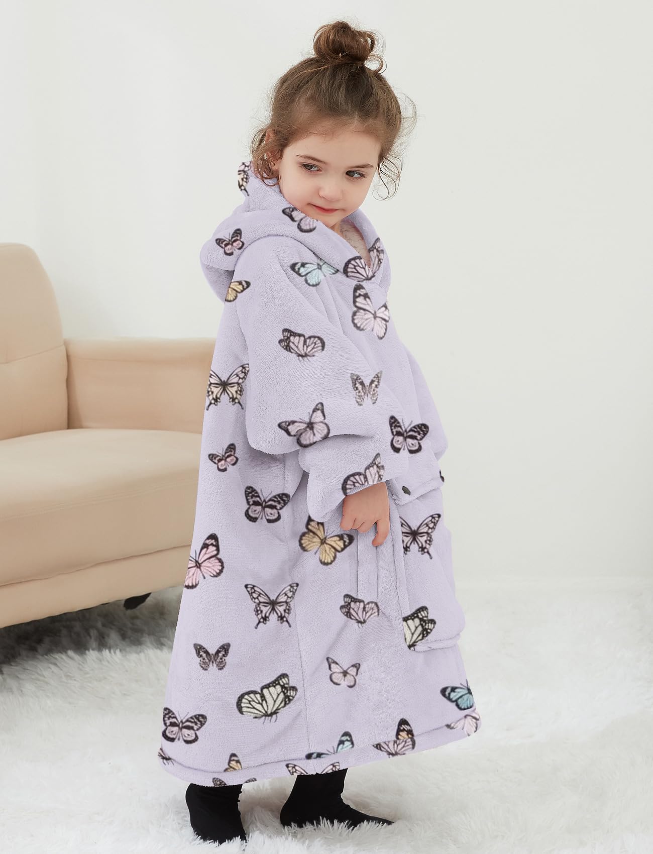 NOUKOW toddler wearing the blanket hoodie in living room for comfort and hands-free warmth