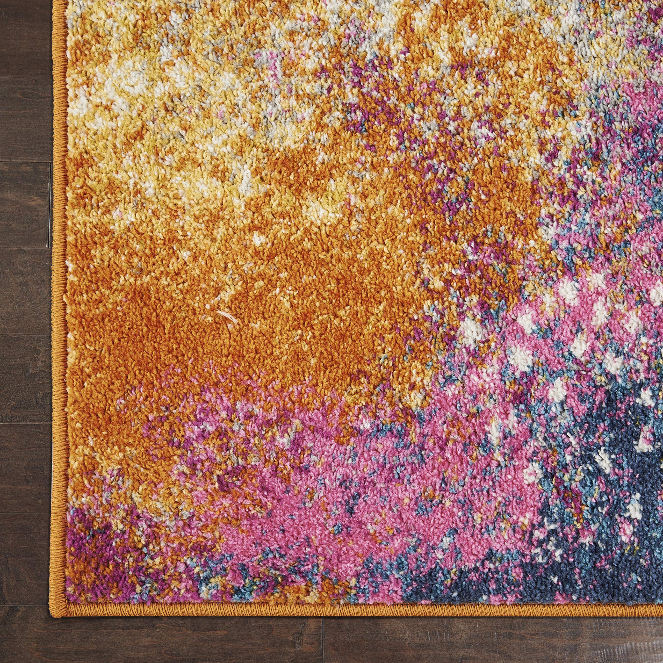 Nourison Passion Sunburst under sofa shows scale and room-defining size