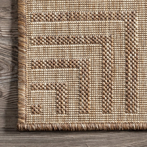 nuLOOM Asha next to chair showing scale and how it anchors small seating areas