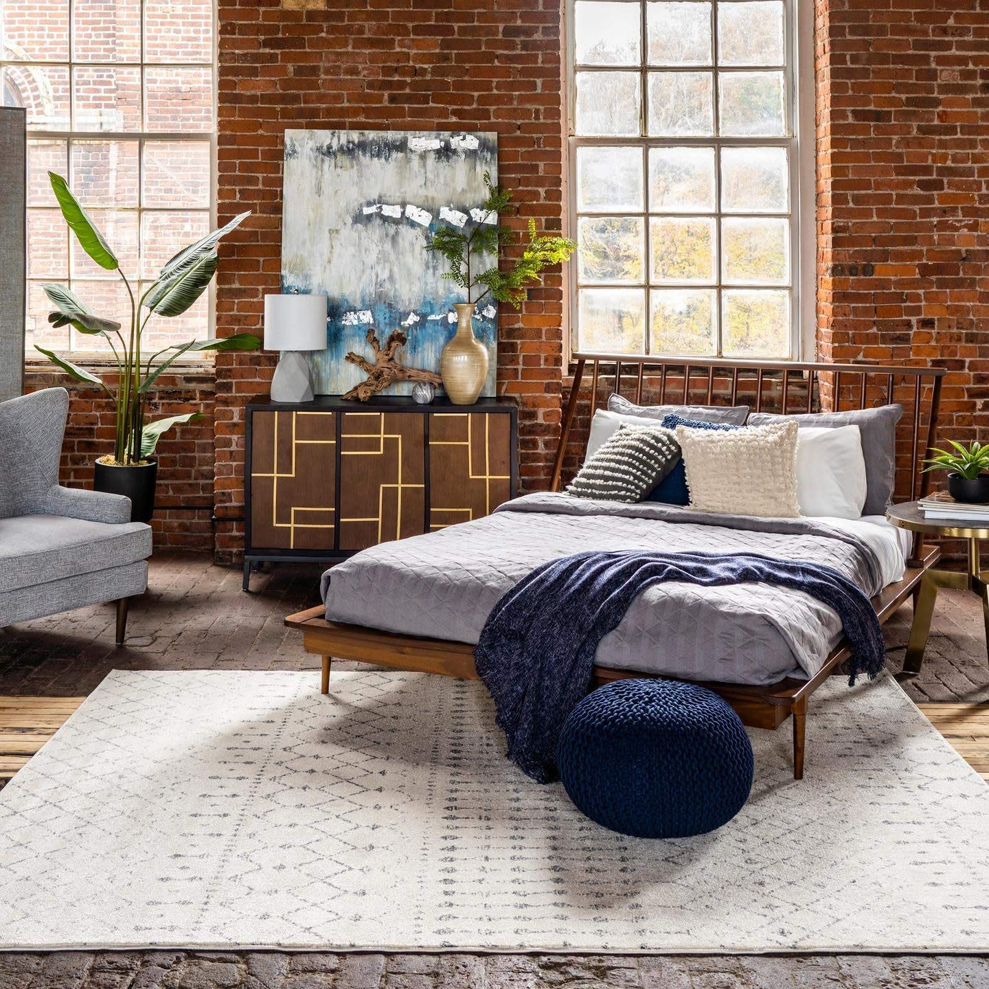 nuLOOM rug beside sofa showing 7x9 scale and furniture anchoring benefit