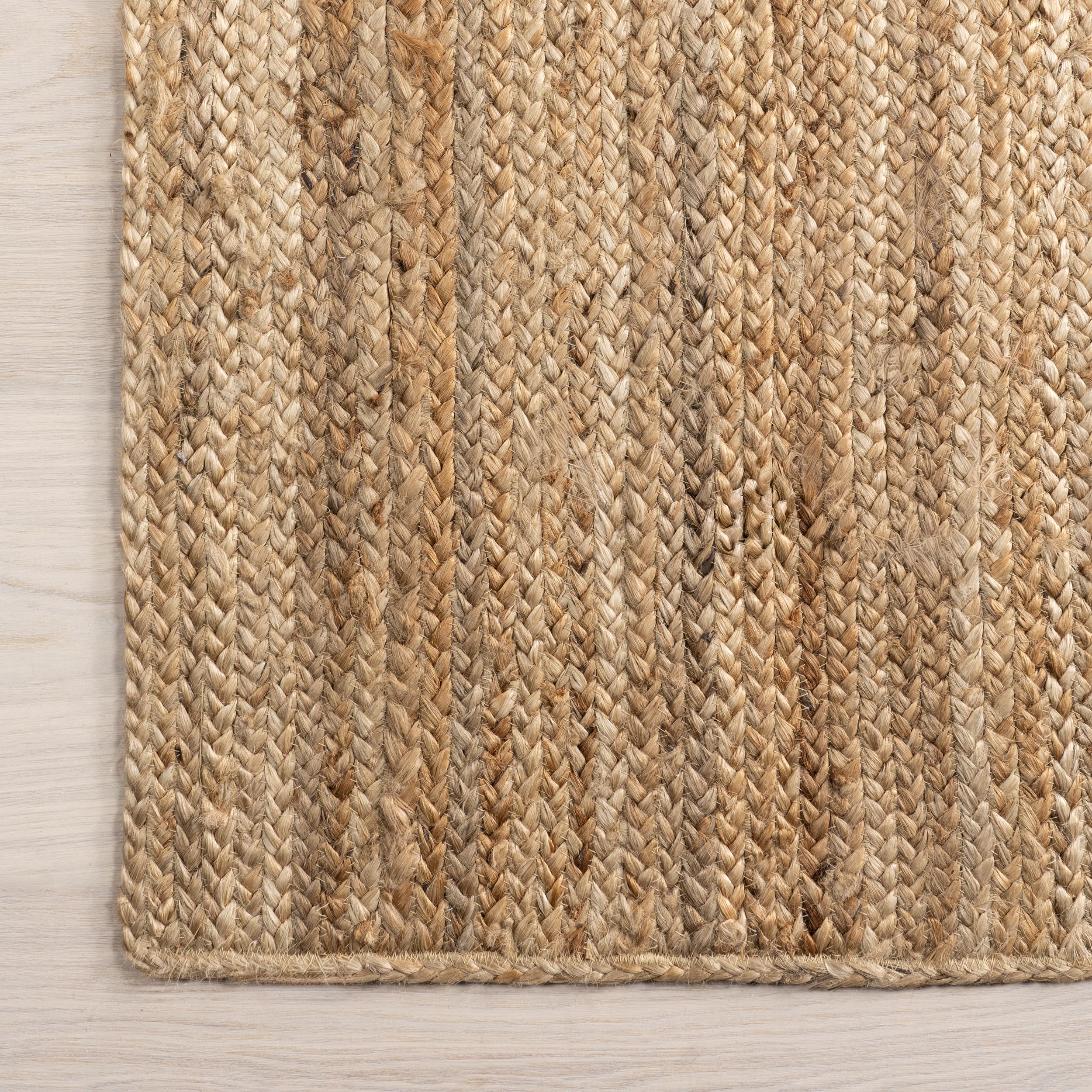 nuLOOM Rigo Natural placed under a small dining table adding warm focal point