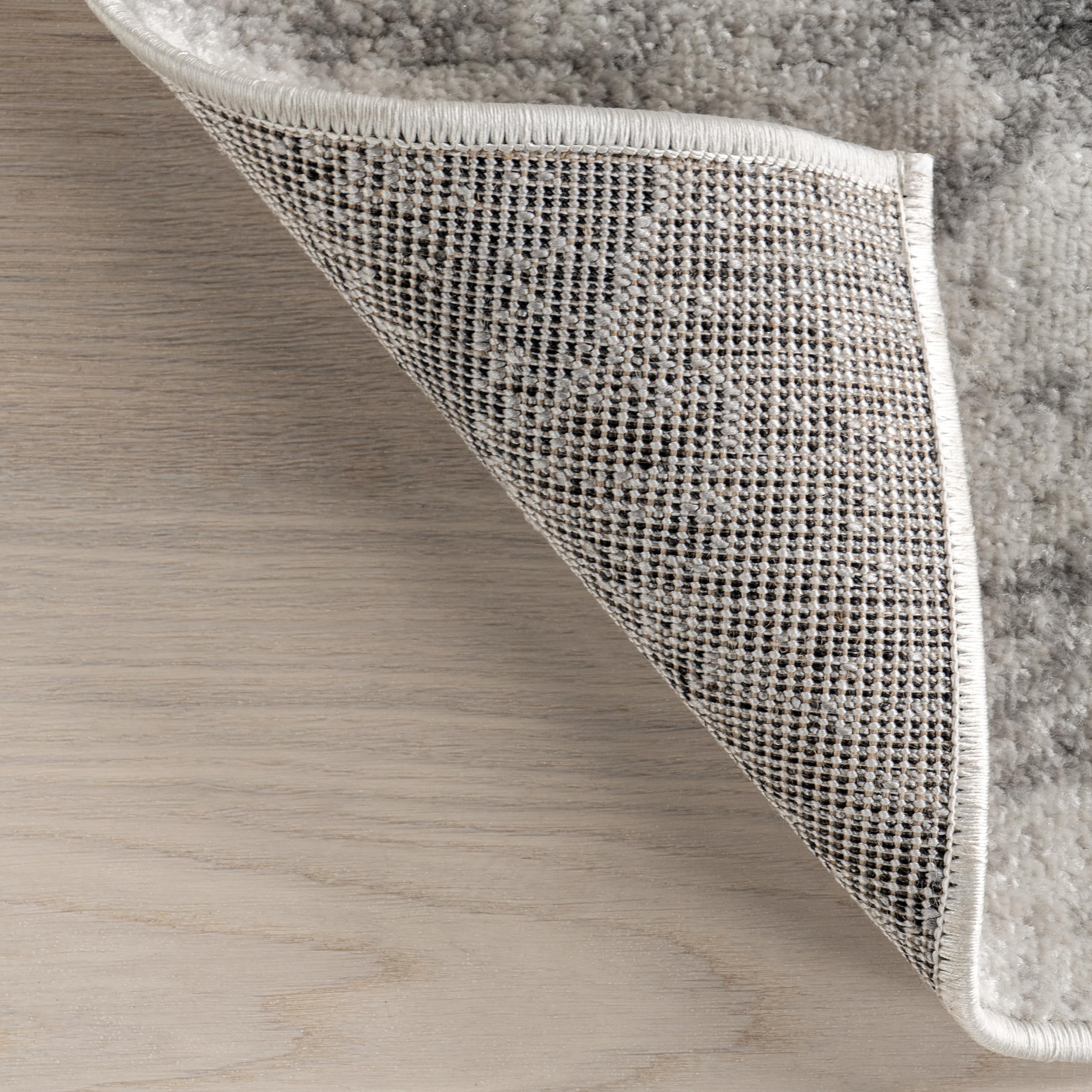 nuLOOM Thigpen layered over larger rug for depth and styling versatility