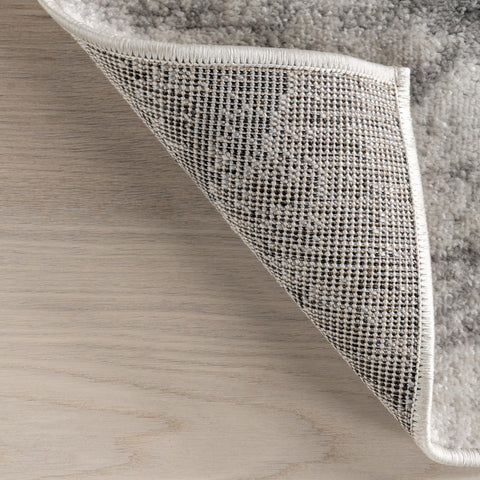 nuLOOM Thigpen layered over larger rug for depth and styling versatility