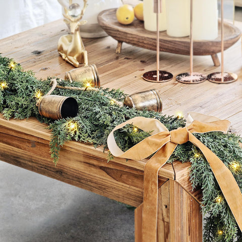 NUTIKAS garland draped on mantel creating warm holiday focal point