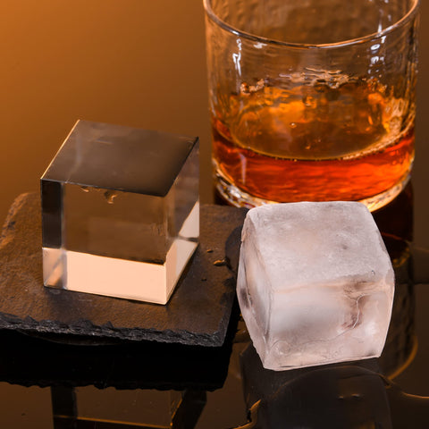 OKLGO single 2-inch clear ice cube in a whiskey glass enhancing presentation