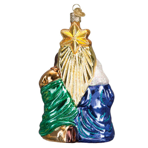 Old World Christmas ornament hanging on tree reflecting lights and adding spiritual ambiance