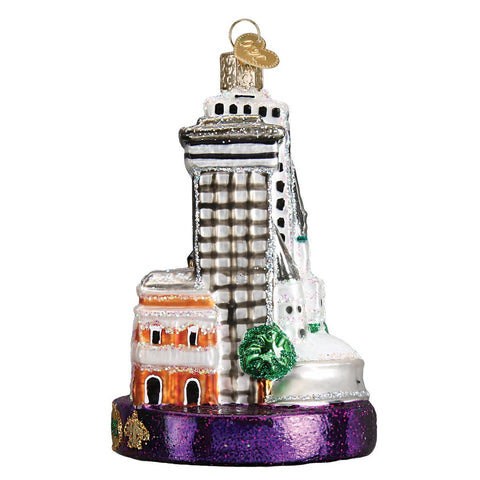 Old World Christmas ornament hanging in a decorated tree adding Mardi Gras color