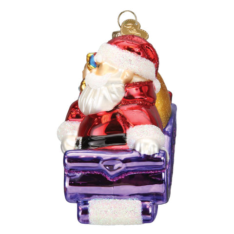 Old World Christmas ornament hung on a Christmas tree illustrating sparkle and light reflection